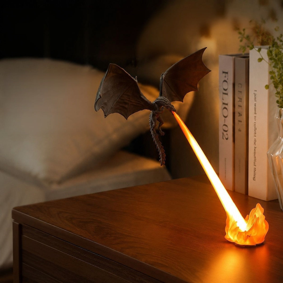 Orange flame flying dragon night light on a bedside table